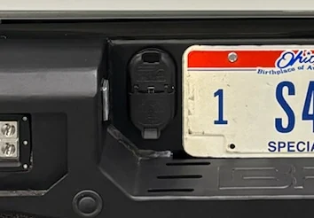 Trailer wiring connector installed in a vehicle rear bumper
