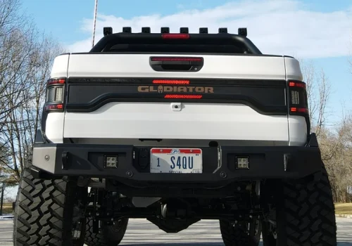 Rear-facing auxiliary LED light pods installed in a Jeep rear bumper
