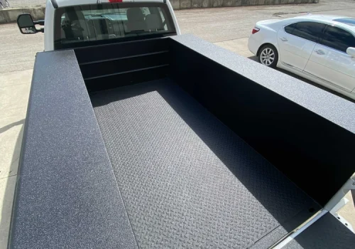 Protective spray-on liner covering a commercial truck bed