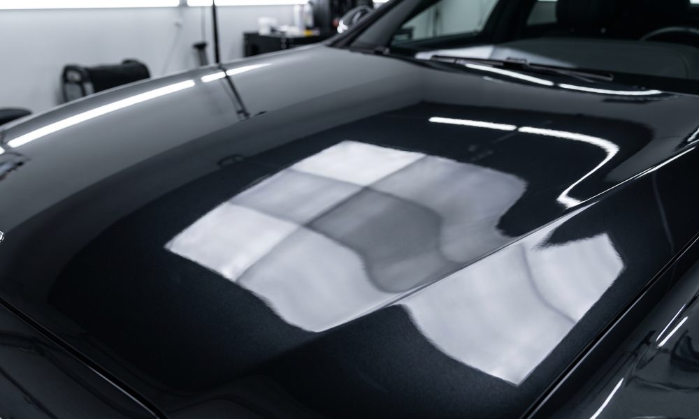 Premium ceramic coating deep mirror gloss on dark vehicle hood