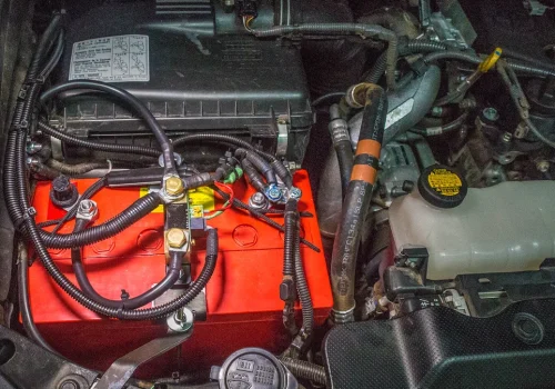 Aftermarket AGM automotive battery installed in an engine bay